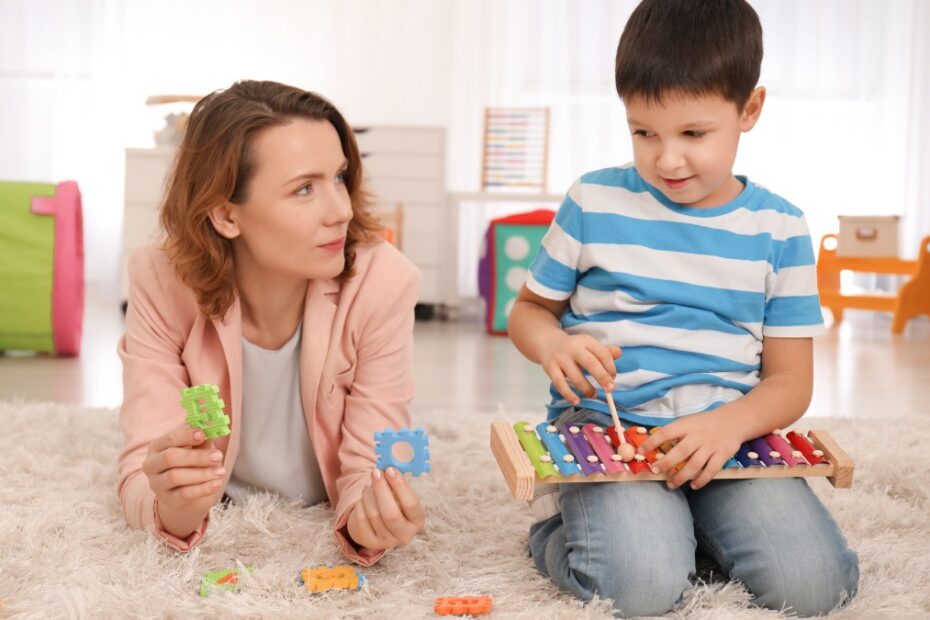 A pediatric specialist performing an autism screening with a child.